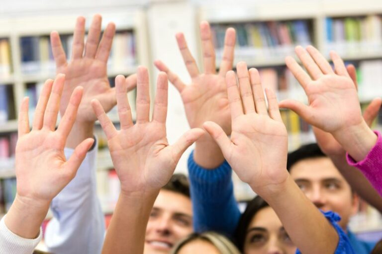 Jóvenes levantando la mano